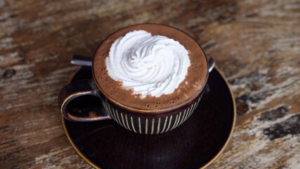 Top view of a cup of dairy free hot chocolate with cream on top.