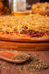 Pizza with beef and cream, mozzarella cheese and potato sticks - Traditional brazilian pizza de strogonoff - Closeup.