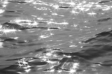 Detail of a sunlight reflecting in glittering sea. sparkler in water - background. sea water with...