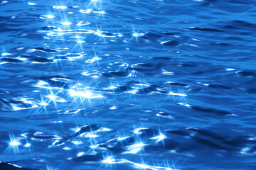 Detail of a sunlight reflecting in glittering sea. sparkler in water - background. sea water with...