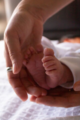 beautiful feet of a newborn baby on a white sheet