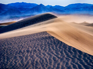 Fototapeta na wymiar USA, California. Death Valley National Park, Mesquite Flats Sand Dunes, blowing sand at sunrise.