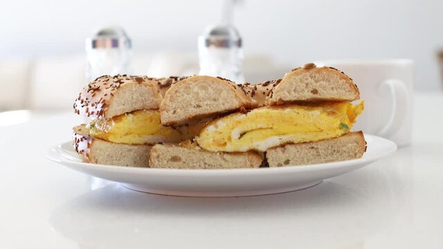 Serving a Breakfast Bagel with Egg and Cheese