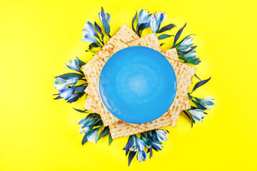 Top view of plate, matzos and flowers. Passover jewish holiday.