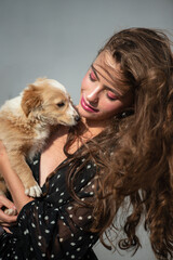 Dog pet. Cute puppy with beauty woman. High fashion model girl hugging with pup.