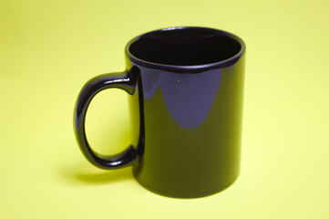 Black cup with yellow background