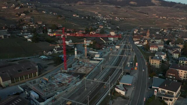 Aerial of large cranes at suburban construction site