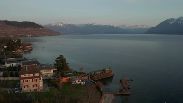 Flying over lakeside houses towards a vast and beautiful lake