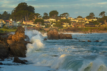 Winter waves crashing against the coastline rocks of Pacific Grove, California. © Danita Delimont