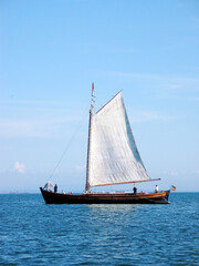 Original traditional sail boat on river Tagus in Lisboa (Portugal, Europe), authentic old commercial vessel propelled by sails.
