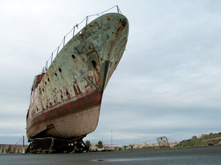 Beautiful old ship rusting in a boatyard, authentic old sea craft awaiting restoration, view from...