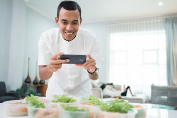 portrait of male home catering service preparing lunch box for takeaway food online order