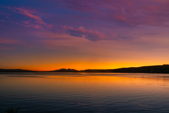 Mount Ngauruhoe and Ruapehu volcanic mountains in the distance as sunset turns to night viewed from Lake Taupo © Stewart