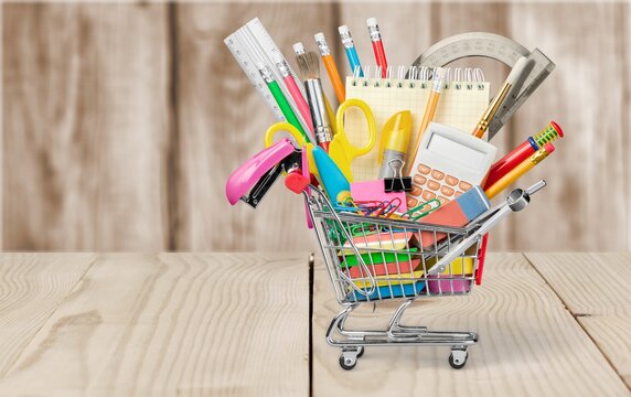 Stationery objects in mini supermarket cart on desk