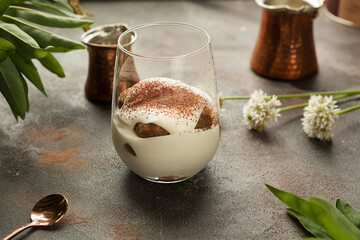 beautiful white cream dessert in a transparent glass.
tiramisu in a transparent glass.