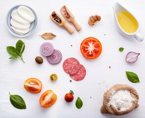 The ingredients for homemade pizza on white wooden background. - 418223189