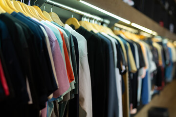 Assortment of summer and autumn clothing in modern garment store interior