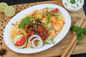 Fish biryani , Spicy and delicious Malabar biryani or Hyderabadi biryani, Dum Biriyani, pulao Kerala India Sri Lanka . basmati rice, herbs, raitha for Ramadan Kareem, Eid
