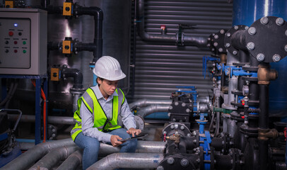 Industry engineer under checking the industry cooling tower air conditioner is water cooling tower...