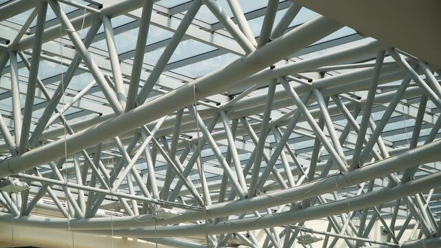 Roof of moden buildings. Abstract high-tech architecture background, internal metal frame structure of glass roof arch with lockable windows sections