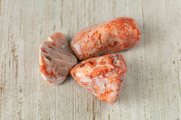 heliolite nature textured pink stone on wood white surface