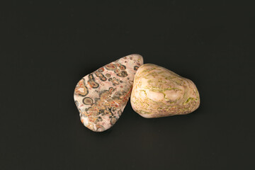 leopardskin jasper nature textured pink stone on black surface