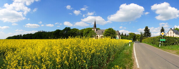 Church And Rape Field In Buchholz In The Eifel