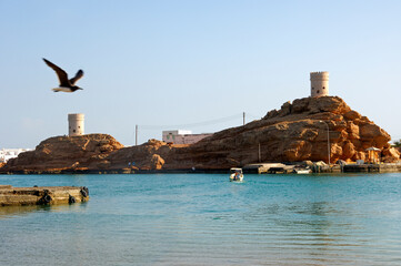 Fototapeta premium Old Watch Towers On Rocks At The Harbour Gate In Sur, Sultanate Of Oman