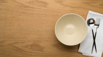 Table Setting Background, mock up ceramic bowl, fork and spoon on white napkin, clean bowl