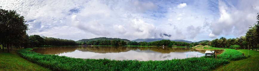 Beautiful landscape green tree and shadow on the river with blue sky clouds, Green mountain with blue sky background