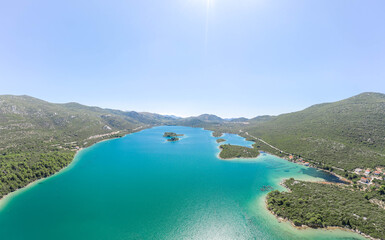 Aerial drone shot of Mali Ston mountains by sea in Croatia summer morning