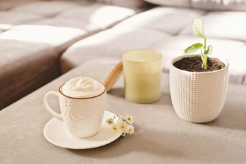 cozy weekend morning mood. coffee cup, scented candle and flower