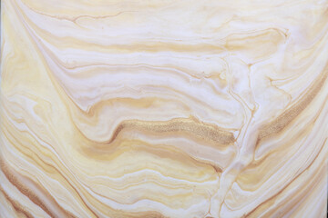 Abstract fluid art background beige and golden colors. Liquid marble.