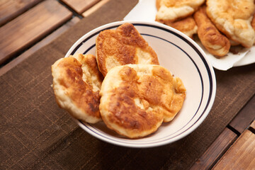 Close up Italian, Panzerotti, calzone served in a plate on a wooden table ready to eat