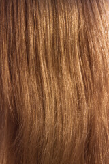 Background of golden hair closeup; Golden blond hair texture with light shimmering
