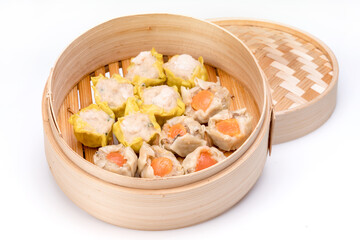 Pork and Crab Dumplings Ready to serve in an oriental woven bamboo basket on a white background