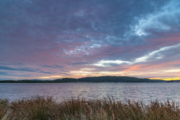 Sunrise at the waterfront with cloud cover