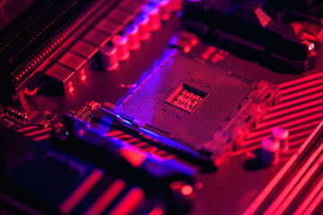 Blurred background. Socket am4. Close up of the AM4 socket for the motherboard with neon blue and...