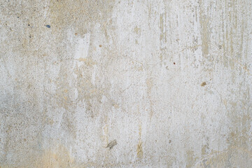 Texture of old gray concrete wall outside, close-up. Faded white paint, scratches, damage. Rough background, copy space