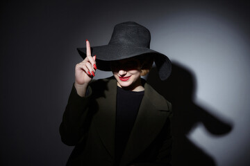 the blonde covered her eyes with the brim of her black hat