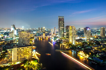 Bangkok Transportation at Dusk with Modern Business Building along the river