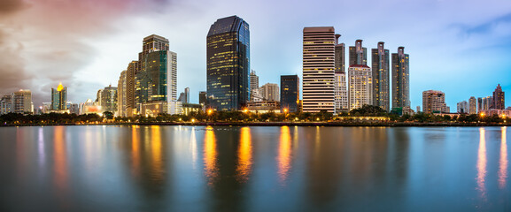Panorama of Bangkok Cityscape, Business district with Park in the City at dusk