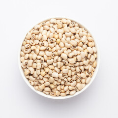 Close up of Organic soybean,  (Glycine max ) or soya bean dal on a ceramic white bowl. Top view 