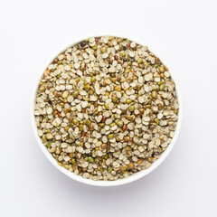 Close up of Organic split green urad dal (Vigna mungo) or  on a ceramic white bowl. Top view 