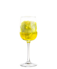 green rose in a glass of wine. isolated on white.