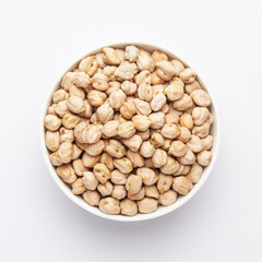 Close up of Organic small chhole chana or Kabuli chana (Cicer arietinum) or whole white Bengal gram dal on a ceramic white bowl. Top view 