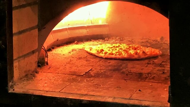 Pizza Cooking In A Gas Brick Portable Oven. Time Lapse. 4K