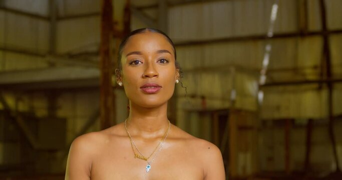 Epic closeup of a pretty face brown skin girl at an abandoned warehouse in the Caribbean