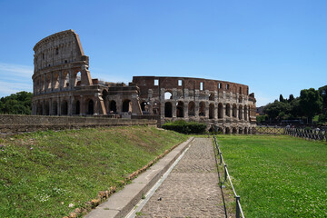 Fototapeta na wymiar Ancient Roman amphitheater and gladiator arena Colosseum, heart of Roman Empire, famous tourist landmark, guided tour concept, Rome, Italy