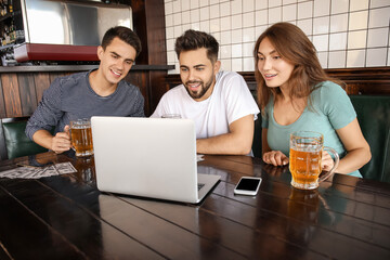 Young people placing sports bet in pub